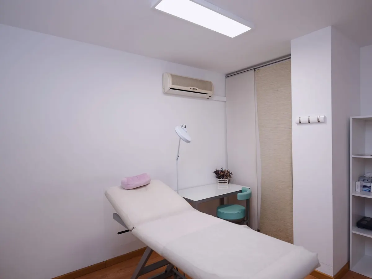 A bright consultation room with an examination bed