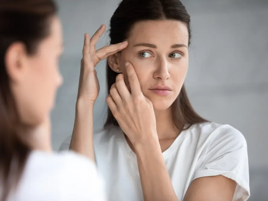Anxious,Young,Woman,Look,In,The,Mirror,Worried,About,Wrinkle
