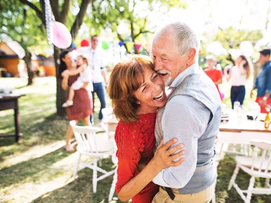 Happy mature couple enjoying 4th of July festivities at a picnic party in San Antonio