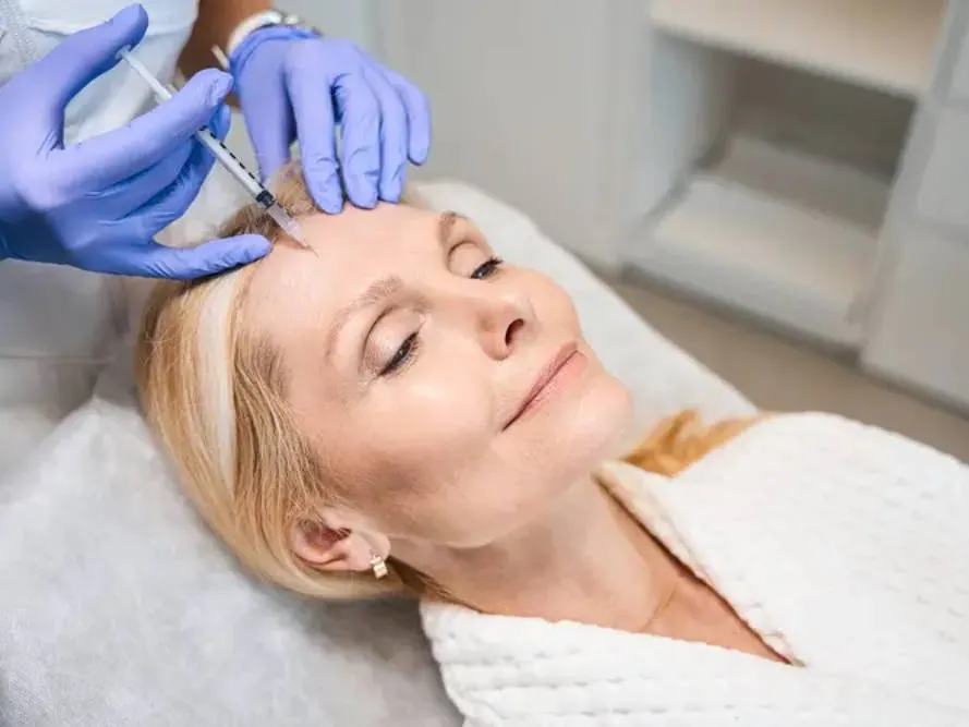 A woman getting BOTOX injections in her crow's feet