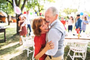 Happy mature couple enjoying 4th of July festivities at a picnic party in San Antonio